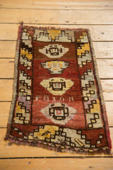 Distressed Oushak rug's left barber pole border with geometric patterns and abrashed field.