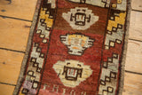 Distressed Oushak rug close-up: barber pole border, medallion, and rich copper, ivory, brown hues.