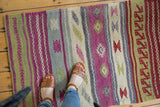 Hand woven Jijim rug with plain weave and embossed geometric bands in aubergine, sage, and denim tones.