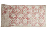Vintage Distressed Sivas fragment rug, faded raspberry red and ivory allover medallion trellis.