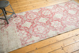 Distressed Sivas fragment rug, pale raspberry red and ivory floral patterns with mostly even wear.