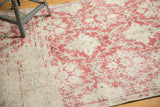 Distressed texture of vintage Sivas rug, with worn pale red and ivory trellis pattern.