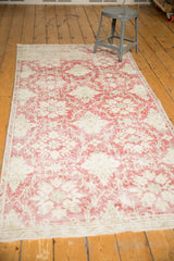 Distressed vintage Sivas rug, faded cochineal red and antique ivory trellis design.