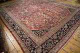 Mahal carpet corner with navy blue floral border and reddish field's expressive arabesques.