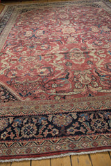 Vintage Mahal carpet corner, featuring navy blue border, expressive floral motifs, and low pile.