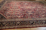 Vintage Mahal carpet corner: navy blue border and cherry red field with arabesques.