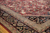 Mahal carpet corner: cherry red field with expressive arabesques and navy blue border.