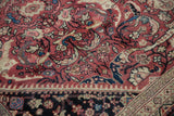 Mahal carpet border detail with expressive arabesques on dusty raspberry and navy.