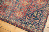 Corner detail of the Vintage Sivas carpet, with a distinct multi-color floral border on navy.