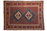 Vintage Afshar rug with a double diamond medallion in aqua blue on a detailed cherry red field.
