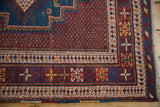 Close-up of a vintage Afshar rug corner showing intricate geometric borders and even, low pile.