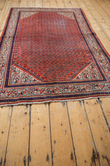 Vintage Mir Sarouk rug corner, rust red boteh field, intricate navy blue and ivory borders.