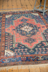 Vintage Kurdish Bijar rug detail with navy field, thin vinery, and brick red geometric borders.
