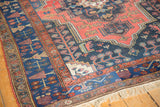 Vintage Kurdish Bijar rug with navy blue border, stylized tree motifs, subtle wear.