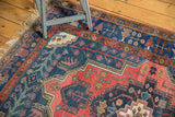Vintage Kurdish Bijar rug corner, natural fringe, showing a worn navy and brick red pile.