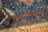 Kurdish Bijar rug's lower border with navy, brick red, ivory floral vinery and fringe.