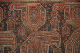 Antique Qashqai rug detail: hand-knotted geometric boteh, terracotta, navy, and even wear.