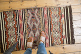 Hand-woven Jijim rug runner with embossed geometric patterns and rich banded coloration.