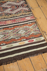 Textured jijim embroidery and plain weave horizontal bands in brown, ivory, orange, wine red.