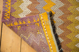 Hand-knotted vintage Jijim rug's folded corner, showing a zigzag pattern and construction.