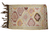 Vintage Jijim rug with geometric diamond starburst patterns in beige, tangerine, raspberry, gold.
