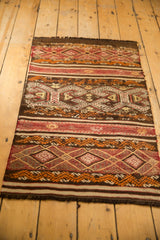 Horizontal banded weave with intricate geometric motifs in dark chocolate, ivory, and raspberry.