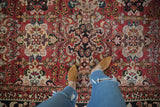 Vintage Mahal Carpet's rich brick red field and ivory floral cartouches, showing even pile wear.