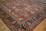 Vintage Mahal carpet corner, charcoal navy border, brick red field, with even wear.