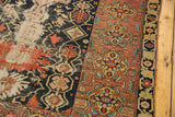 Malayer rug: worn navy field showing foundation and a detailed madder border.
