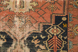 Intricate navy, madder red, and ivory patterns of a vintage Malayer rug with visible foundation.