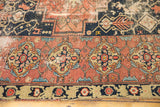 Wide madder root red border of Malayer rug with intricate gold, navy motifs, visible wear.