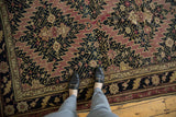 Armenian Karabagh carpet's sharp serrated pattern in dark navy, mauve, and dusty gold.