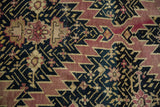 Armenian Karabagh carpet's dramatic serrated geometric pattern in deep navy, mauve, and pale gold.