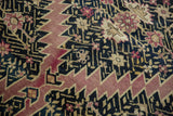 Armenian Karabagh rug detail: serrated aubergine contour with gold floral motifs on navy.