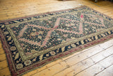 Antique Karabagh carpet border with dark navy floral motifs and serrated mauve field.