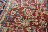 Vintage Kerman carpet detail: cherry red field, sprawling floral bouquets, navy, blush, celadon, wear.