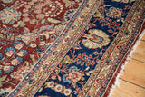 Hand knotted Kerman rug border, navy blue and cherry red floral patterns, with tattered fringe.