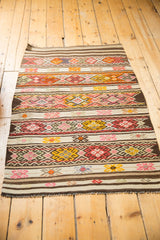 Vintage Jijim rug with densely ornamented geometric bands in red, orange, and ivory.