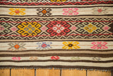 Vintage Jijim rug with horizontal bands of plain weave and vivid geometric patterns.
