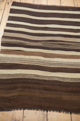 Hand woven Turkish Kilim, displaying tone-on-tone brown, ivory, and grey striating bands.