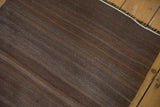 Hand-woven vintage Turkish Kilim rug with striating chocolate brown and silver tones.