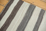 Close-up of handwoven vintage Turkish Kilim with chocolate brown and silver tone-on-tone stripes.