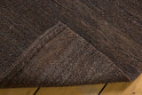 Close-up of vintage Turkish Kilim's natural shorn brown wool texture and secured edge.