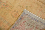 Distressed Oushak rug pile showing even wear and faint foundation, revealing a colorful hand-knotted reverse.