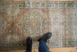 Distressed antique Kerman runner's unique sun-like floral medallion with pale bronze and sky blue.