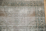 Distressed antique Kerman rug pile, showing foundation and muted floral design.