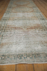 Distressed antique Kerman runner's low pile, revealing mostly even wear to knot heads.