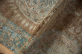 Distressed pile of an antique Kerman runner, showing mostly even wear and faded bronze and ocean blue hues.