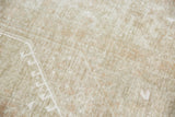 Distressed vintage Oushak pile showing subtle white pattern and earthen ivory tones.