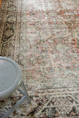 Distressed texture of the vintage Mahal carpet, showing muted rose, blue, and ivory tones.